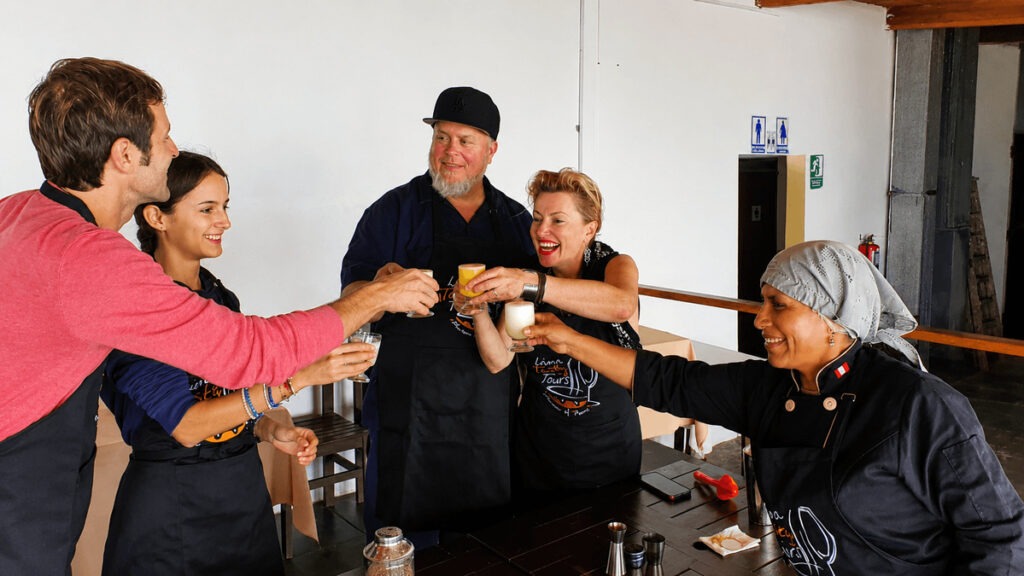  ⁠International travelers toasting with freshly made Pisco Sours during a Lima Tasty Tours cooking class experience.⁠